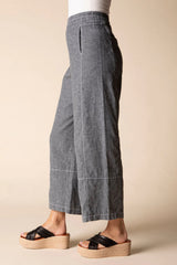 Profile of a model wearing charcoal grey linen cropped pants