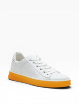 White sneaker with orange sole on a white background