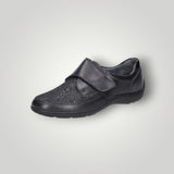 Black orthopedic shoe with a strap on a white background