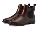 Pair of brown leather boots with a buckle on a white background