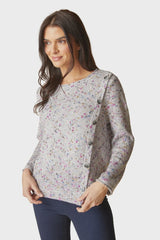 Women wearing a knit sweater with a row of buttons down one side