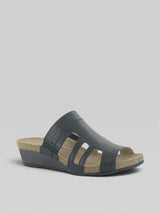 Black wedge sandal with cork insole on a gray background