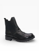 Black Eric Michael Cruz Lug Sole Ankle Boot with rugged outsole and sleek leather upper, stylish for casual or dressy outfits.