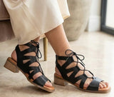 Black Eric Michael Roxanne sandal with woven espadrille-style sole and ankle strap, stylish women's summer footwear.