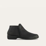 Black Naot Helm ankle boot made of leather, featuring a sleek design and sturdy sole, ideal for casual or dressy outfits.