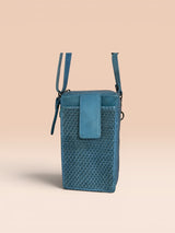 Blue woven handbag with a strap on a beige background