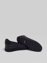 Pair of black loafers on a white background