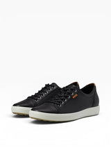 Black sneakers with white soles on a white background