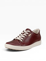 Brown leather sneaker with white laces on a light gray background
