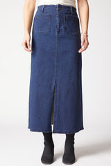 Person wearing a long blue denim skirt on a white background