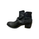 Eric Michael Carlita ankle boot showing black leather upper, side zipper, and stacked heel on a neutral background.