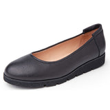 Black leather flat shoe on a white background