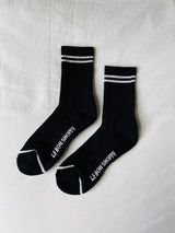 Black Le Bon Shoppe Boyfriend Socks displayed flat, showcasing their soft fabric and relaxed, oversized fit for casual wear.