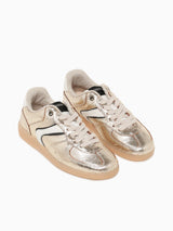 Pair of gold and beige sneakers on a white background