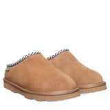 Pair of tan slippers with a white background