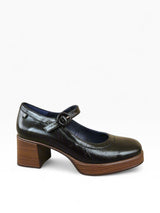 Black shoe with a brown sole on a white background