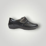 Black leather shoe with a strap on a gray background