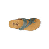 Tan sandal with green straps on a white background
