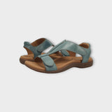 Pair of sandals with blue straps and brown soles on a light gray background