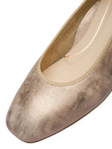 Gold metallic high heel shoe on a white background