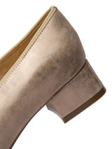 Close-up of a golden beige suede shoe on a white background