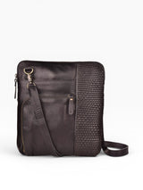 Black crossbody bag and a white background