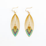 Gold earrings with blue and green beads on a white background