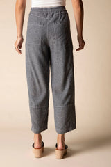 Back of model wearing charcoal grey linen cropped pants