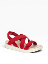 Red sandal with criss-cross straps on a white background