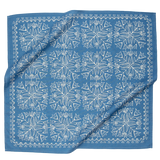 Blue fabric with white floral pattern, folded neatly.