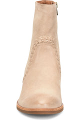 A light beige leather ankle boot with decorative stitching and a side zipper, shown from a front-facing perspective on a white background.