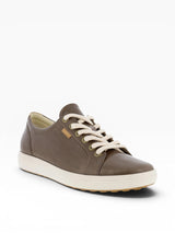 Brown leather sneaker with white laces on a white background
