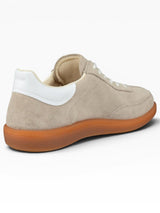 Beige sneaker with white sole on a white background