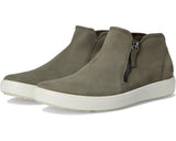 Pair of green ankle boots with a white sole on a white background