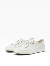 White sneakers with brown accents on a white background