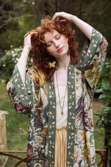 Woman wearing a floral kimono in a natural setting
