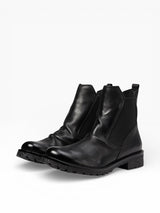 Eric Michael Cruz lug sole ankle boot showing black leather upper, sturdy sole, and stylish ankle height.