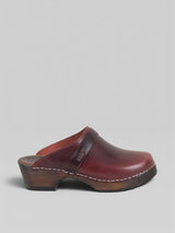 Brown wooden clog shoe on a gray background