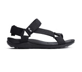 A black sandal with adjustable woven straps and a contoured sole, shown in a side profile on a white background.