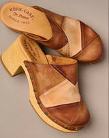 Brown sandal with wooden sole on a gray background