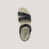 Black sandal with a white sole on a light gray background