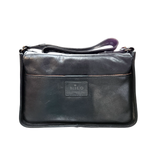 Black leather handbag with a visible brand label on a white background