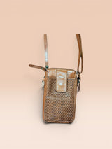 Brown woven handbag with a strap on a beige background