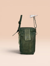 Green woven crossbody bag on a beige background