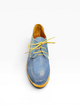 Blue perforated leather shoe with yellow laces on a white background