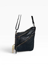 Milo Fiorella 027 leather crossbody handbag with adjustable strap and minimalist design, shown in natural light.