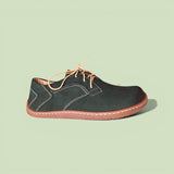 leather shoe with brown accents on a light green background