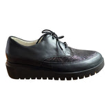 Black leather shoe with thick sole on a white background