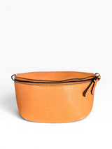 Tan waist bag with a black zipper on a white background