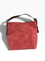 Red handbag with a brown strap on a white background